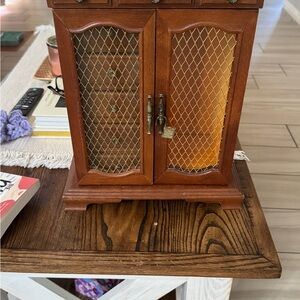 Elegant Wooden Jewelry Box with Gold Accents, mesh door and music box.